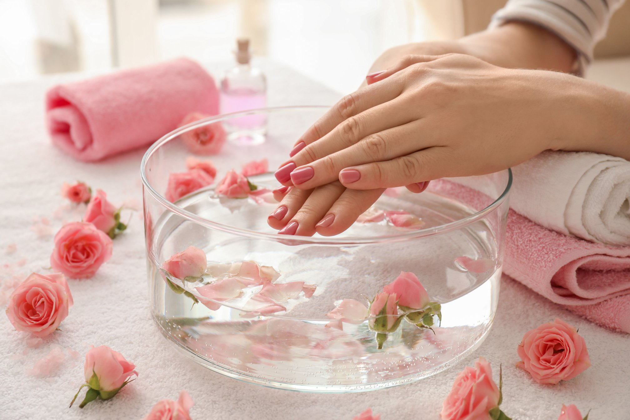 Young Woman Undergoing Spa Manicure Treatment in Beauty Salon